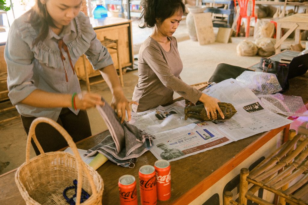Employees at the Fair Trade Village wrapping up some of our purchases in Siem Reap, Cambodia