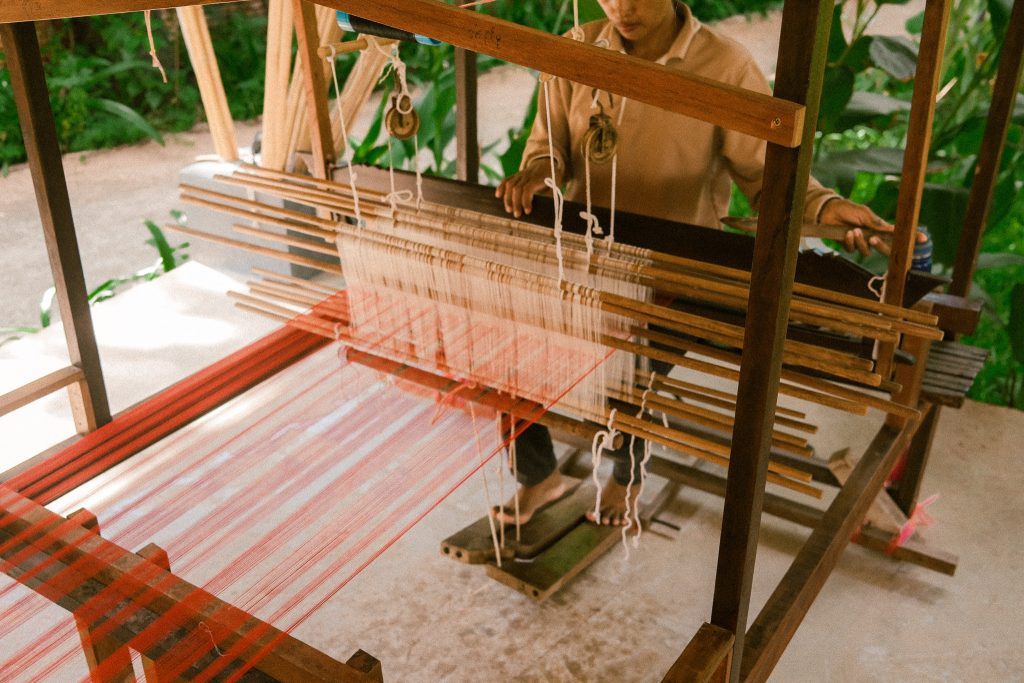 Local artisan working on a silk loom at Satcha in Siem Reap, Cambodia